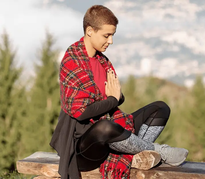 Woman reflecting outdoors during trauma recovery